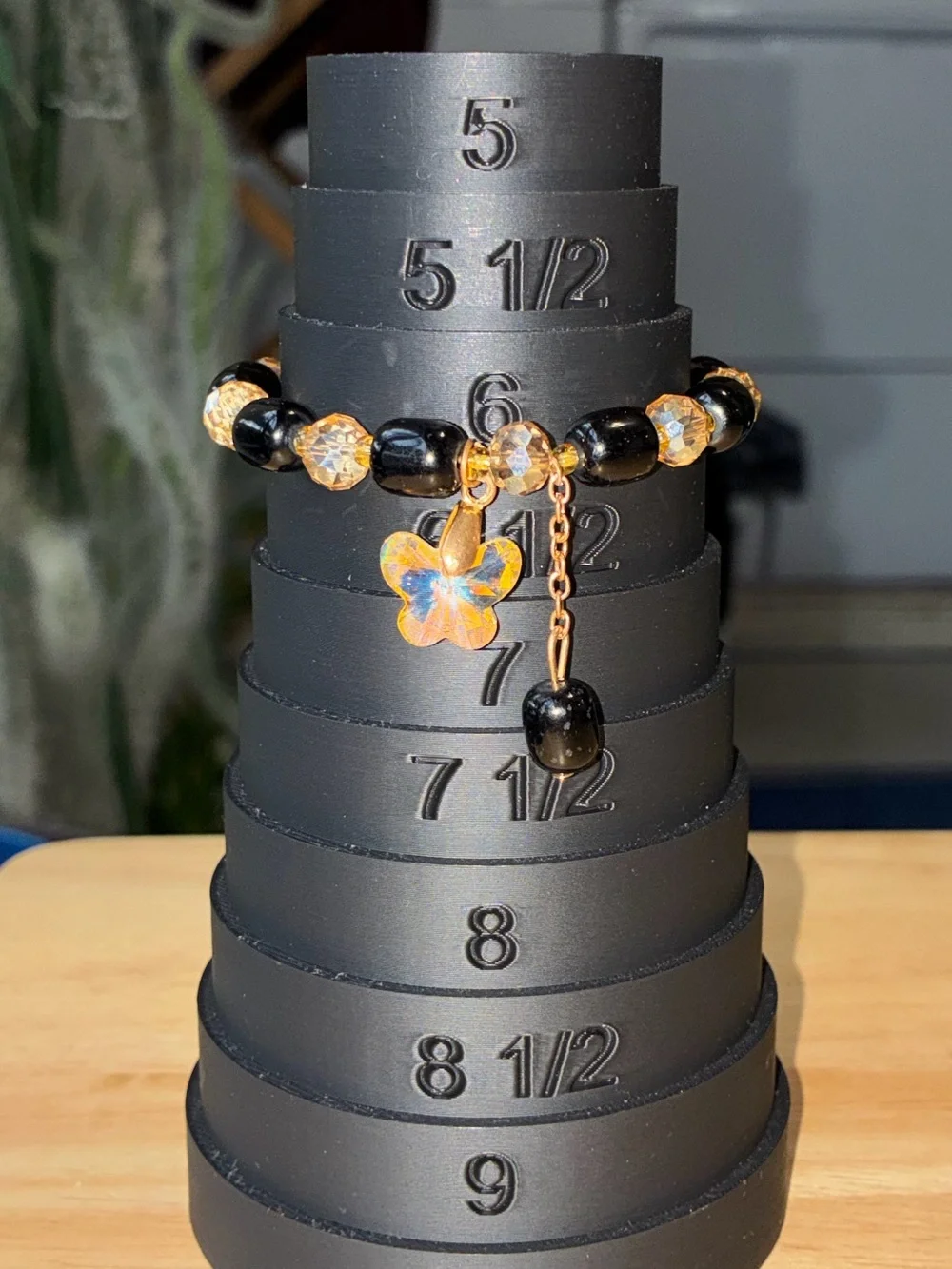 Black and Gold Beaded Stretch Bracelet with Iridescent Flower Charm - Picture 8 of 9